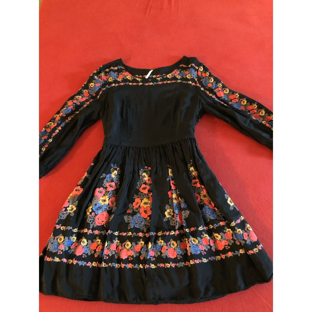Free People black fit & flare dress featuring a vibrant multi-color floral print